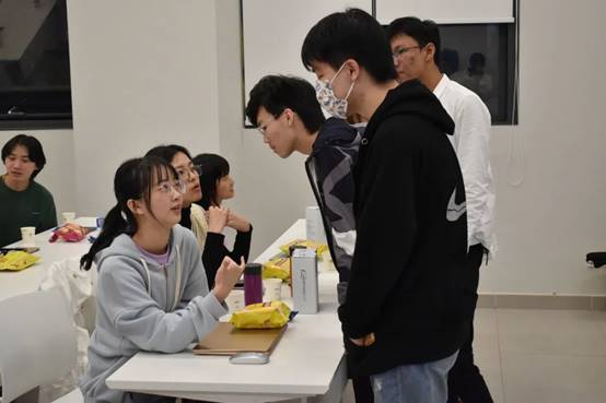 一群人站在桌子边描述已自动生成